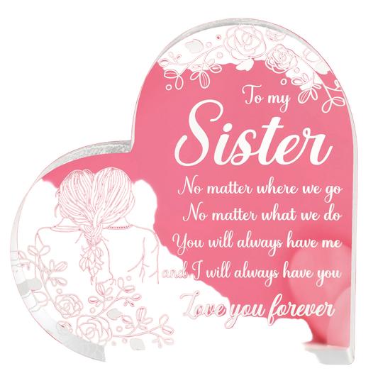 Heart-shaped glass plaque with sister message on a pink background